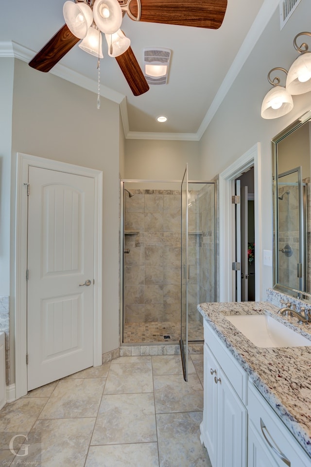 bathroom featuring vanity, ornamental molding, a shower with shower door, and ceiling fan