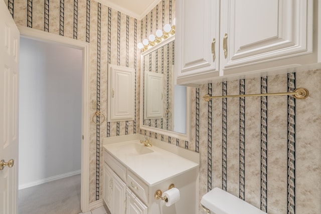 bathroom featuring vanity, toilet, and ornamental molding