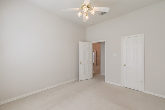 unfurnished bedroom featuring light colored carpet and ceiling fan