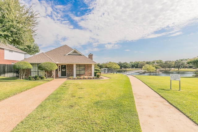 view of front of house featuring a water view and a front lawn