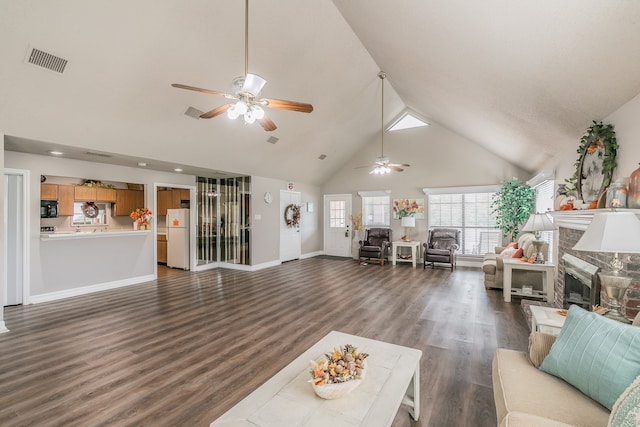 living room with dark hardwood / wood-style floors, ceiling fan, and high vaulted ceiling