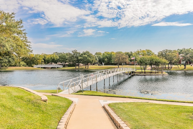 view of community with a water view and a yard