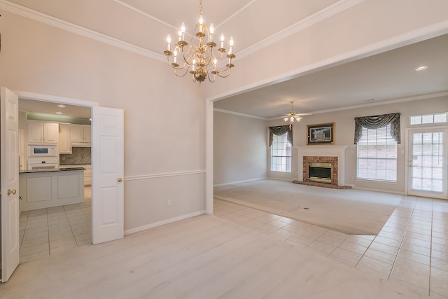 unfurnished living room featuring crown molding, a fireplace, light tile patterned flooring, and ceiling fan with notable chandelier