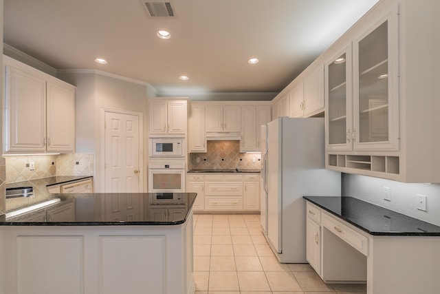 kitchen featuring white appliances, backsplash, kitchen peninsula, light tile patterned floors, and white cabinetry