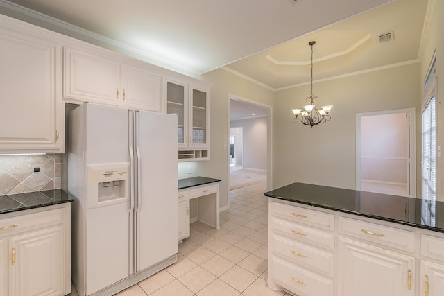 kitchen with white cabinetry, white fridge with ice dispenser, tasteful backsplash, a chandelier, and light tile patterned flooring