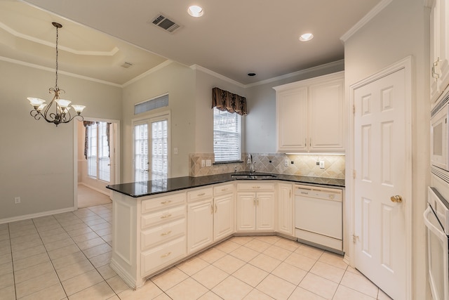 kitchen featuring white cabinetry, a wealth of natural light, sink, and white dishwasher