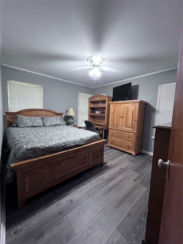 bedroom with ornamental molding, wood-type flooring, and ceiling fan