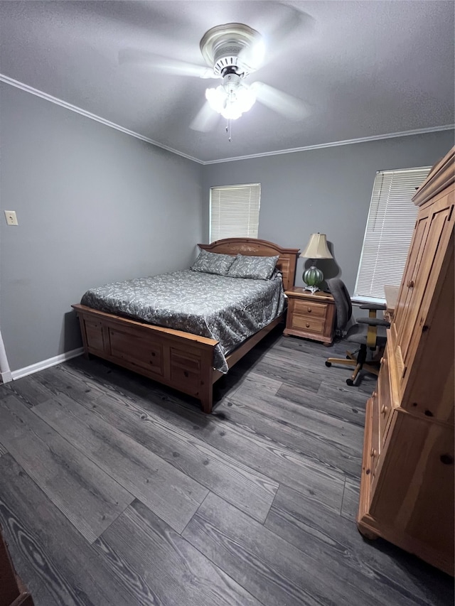 bedroom featuring dark hardwood / wood-style flooring, ornamental molding, and ceiling fan