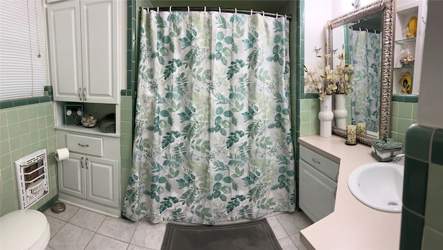 bathroom with vanity, tile walls, heating unit, and tile patterned flooring