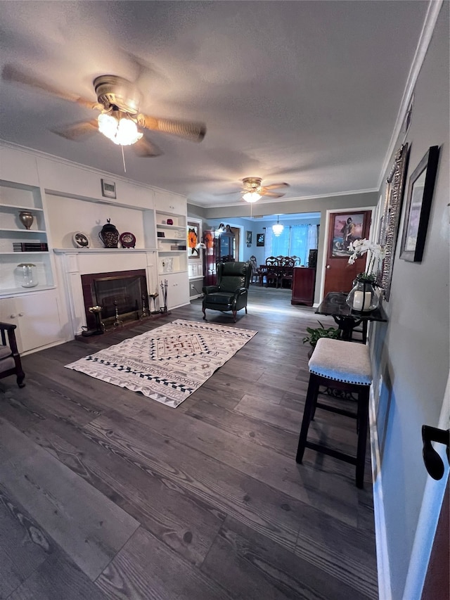 living room with dark hardwood / wood-style floors, a textured ceiling, and ceiling fan