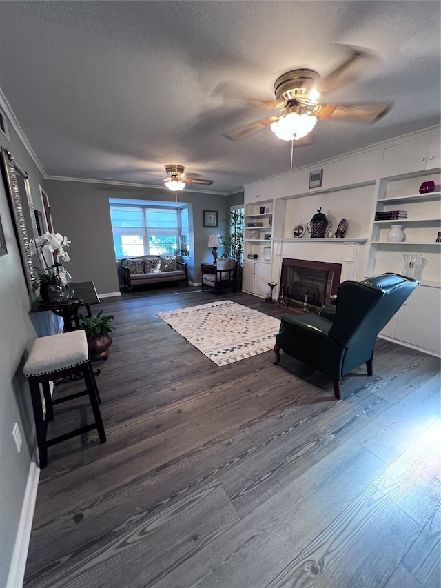 living room with crown molding, a textured ceiling, built in features, and dark hardwood / wood-style flooring