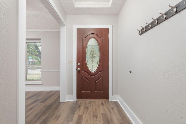 entryway with hardwood / wood-style flooring and a textured ceiling