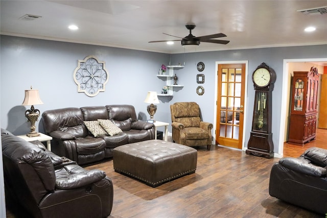 living room with ornamental molding, wood-type flooring, and ceiling fan