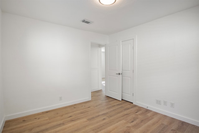 spare room featuring light hardwood / wood-style floors