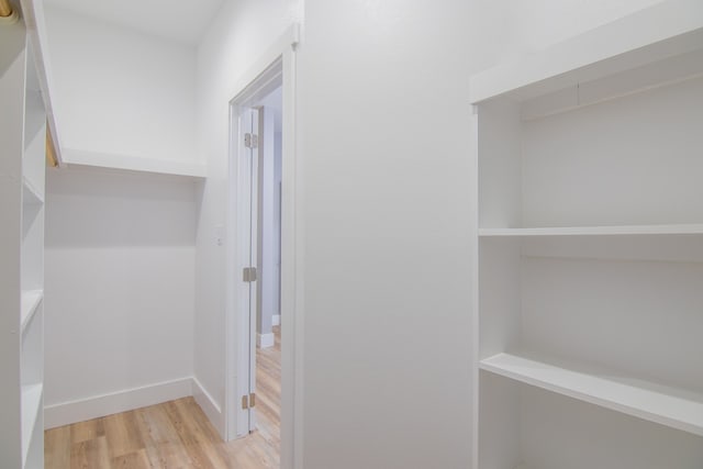 corridor with light wood-type flooring