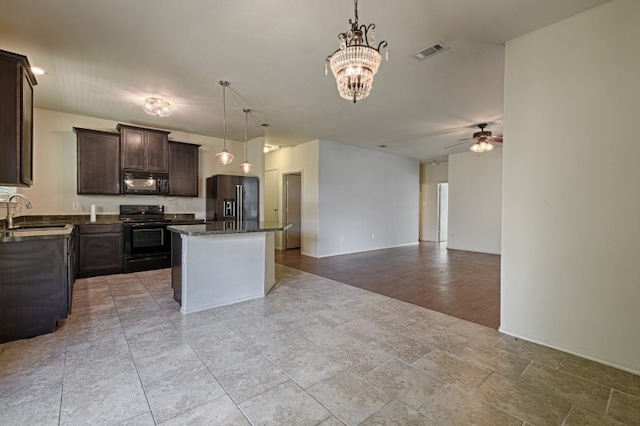 kitchen with ceiling fan with notable chandelier, black appliances, a center island, pendant lighting, and light hardwood / wood-style floors