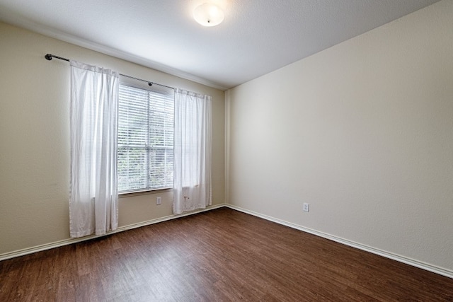 spare room featuring dark hardwood / wood-style floors