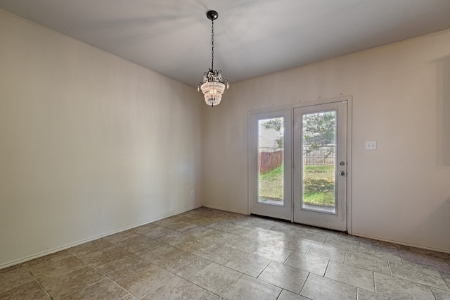 spare room with an inviting chandelier