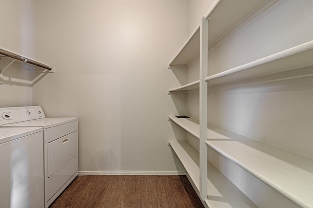 laundry area featuring washer and clothes dryer and dark hardwood / wood-style flooring