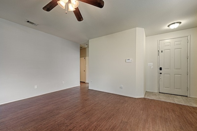 unfurnished room with hardwood / wood-style floors, a textured ceiling, and ceiling fan