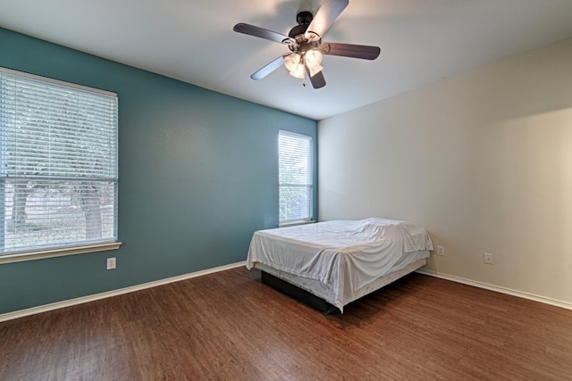 bedroom with dark wood-type flooring and ceiling fan