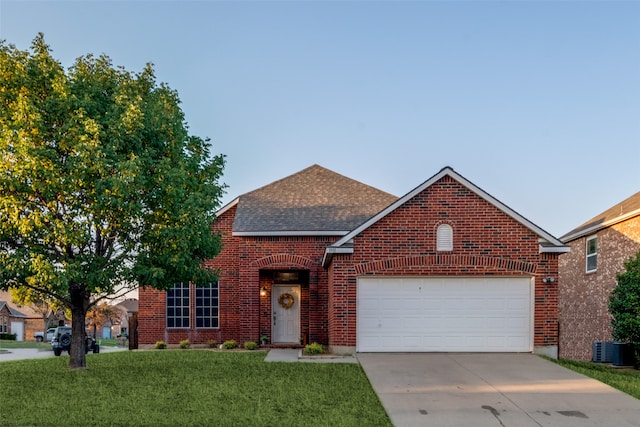 front of property featuring cooling unit, a front lawn, and a garage