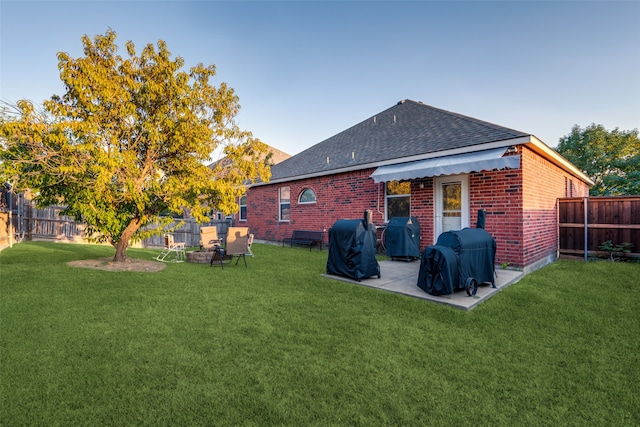 back of property featuring a patio and a lawn