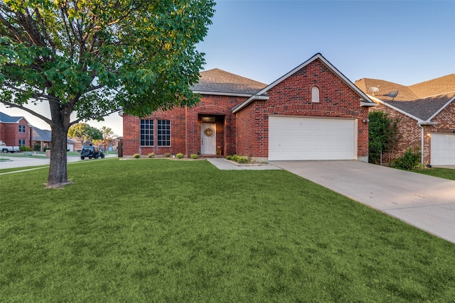 view of front of home featuring a front yard and a garage