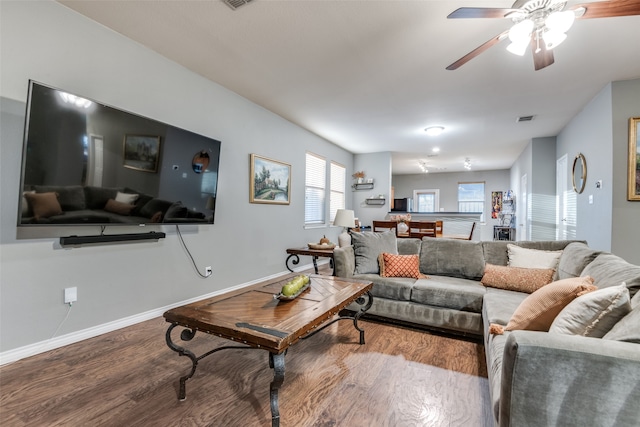 living room with wood-type flooring and ceiling fan