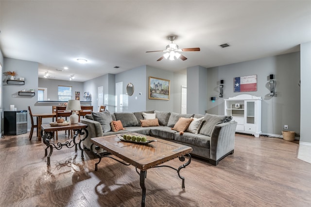 living room with hardwood / wood-style floors and ceiling fan