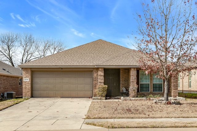 ranch-style home with central air condition unit and a garage