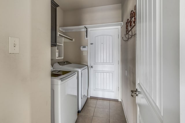 laundry room with cabinets, separate washer and dryer, and light tile patterned flooring