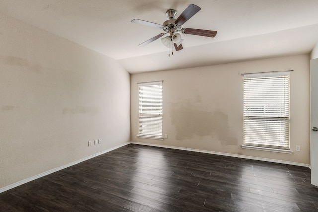 unfurnished room with a wealth of natural light, dark hardwood / wood-style floors, and lofted ceiling