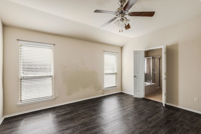 unfurnished bedroom with ceiling fan, dark hardwood / wood-style flooring, ensuite bathroom, and lofted ceiling