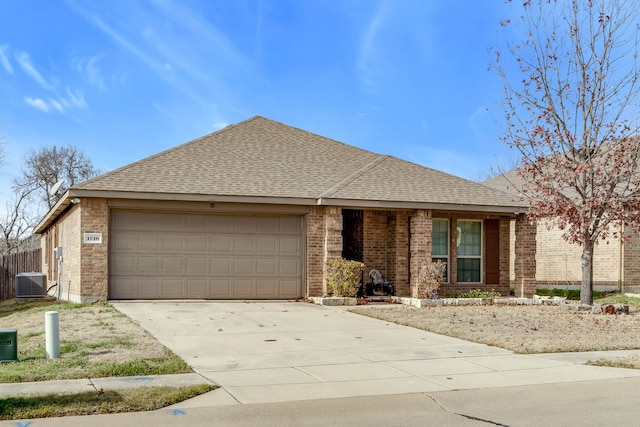 ranch-style home with a garage and cooling unit