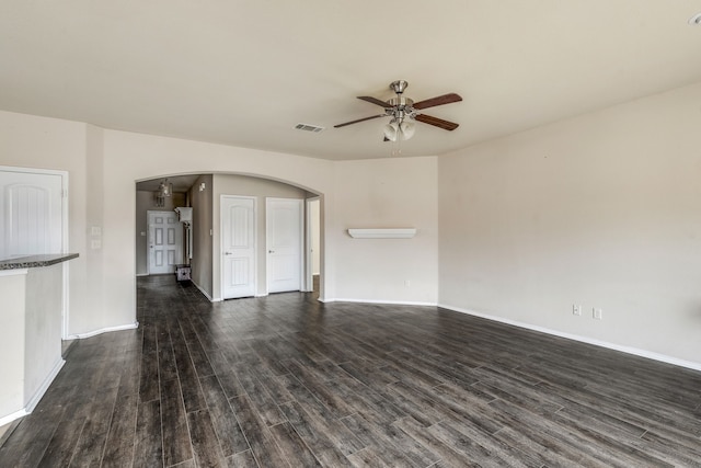 unfurnished living room featuring ceiling fan and dark wood-type flooring