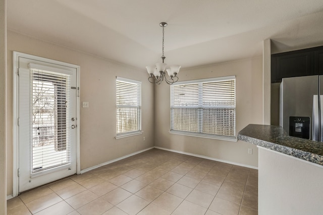 unfurnished dining area with light tile patterned flooring and a chandelier