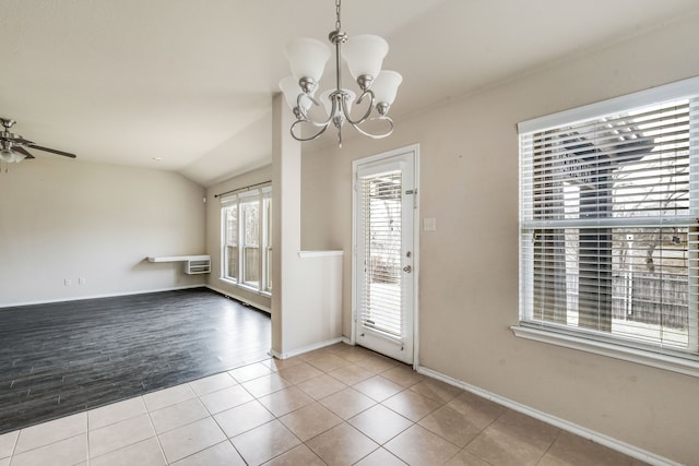 interior space featuring light tile patterned floors, vaulted ceiling, ceiling fan with notable chandelier, and a wall unit AC