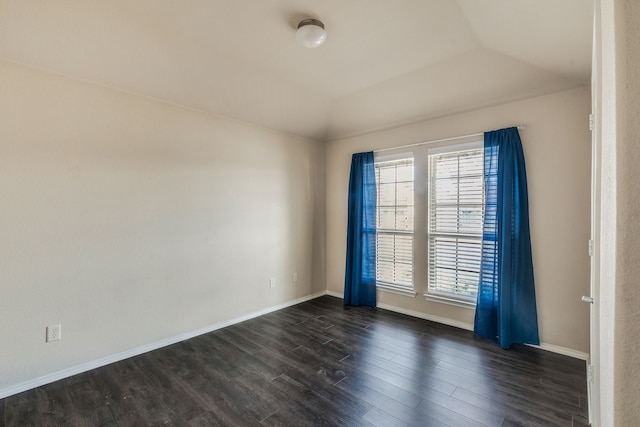 unfurnished room with vaulted ceiling and dark hardwood / wood-style floors