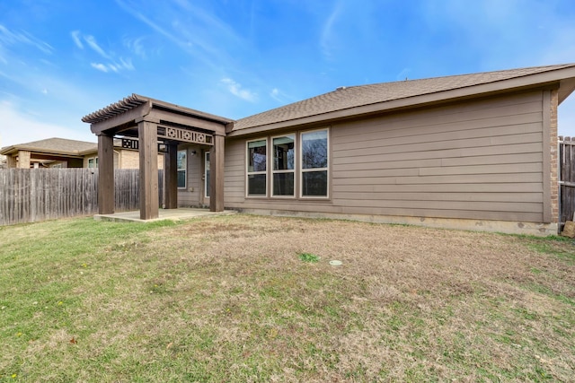 back of property featuring a lawn