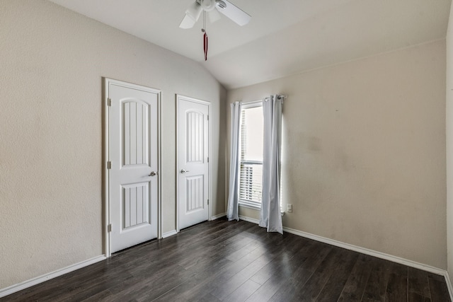 unfurnished bedroom featuring ceiling fan, dark wood-type flooring, and vaulted ceiling