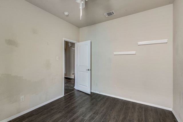 unfurnished room featuring dark hardwood / wood-style flooring