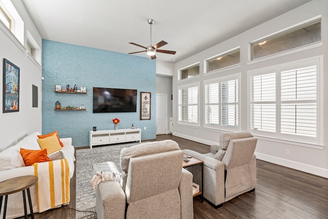 living room featuring ceiling fan and dark wood-type flooring