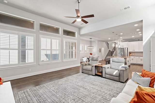 living room with ceiling fan, a healthy amount of sunlight, and dark hardwood / wood-style flooring