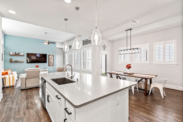 kitchen featuring sink, white cabinets, pendant lighting, and plenty of natural light