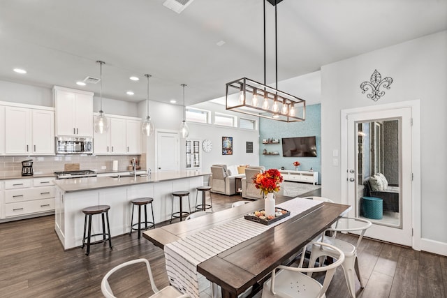 dining room featuring dark wood-type flooring and sink