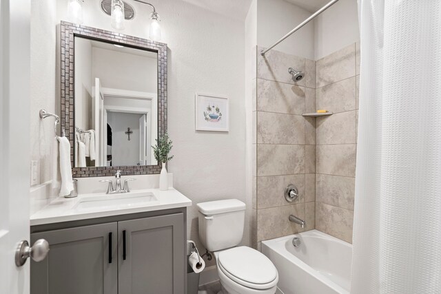 full bathroom featuring vanity, shower / tub combo, and toilet