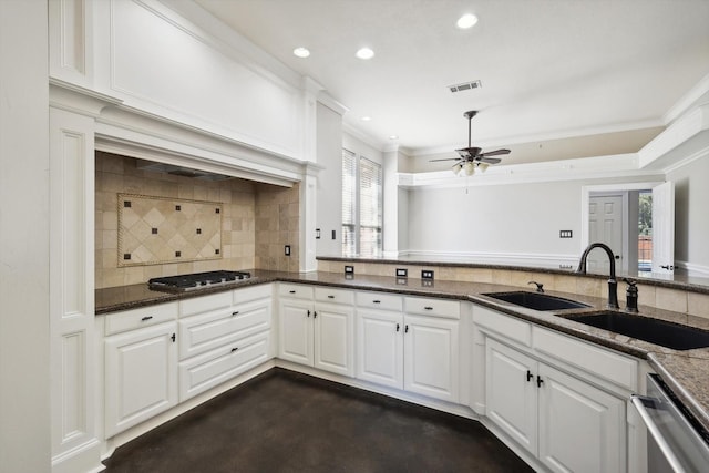 kitchen with dark stone countertops, sink, white cabinets, and stainless steel appliances