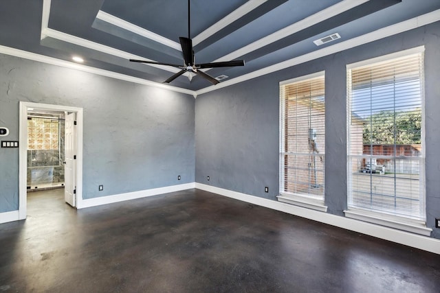 spare room featuring a tray ceiling, ceiling fan, and crown molding