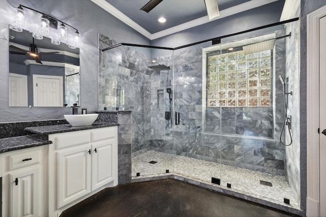 bathroom with a tile shower, vanity, ceiling fan, and crown molding